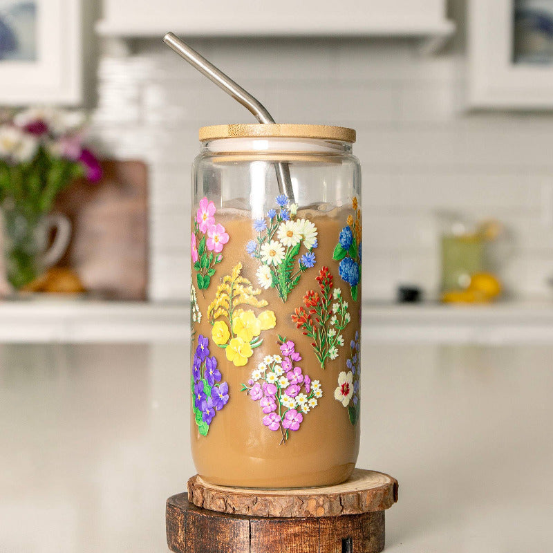 Glass tumbler with floral designs on a wooden stand in a kitchen setting