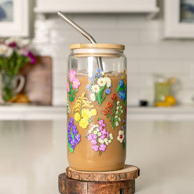 Glass tumbler with floral designs on a wooden stand in a kitchen setting