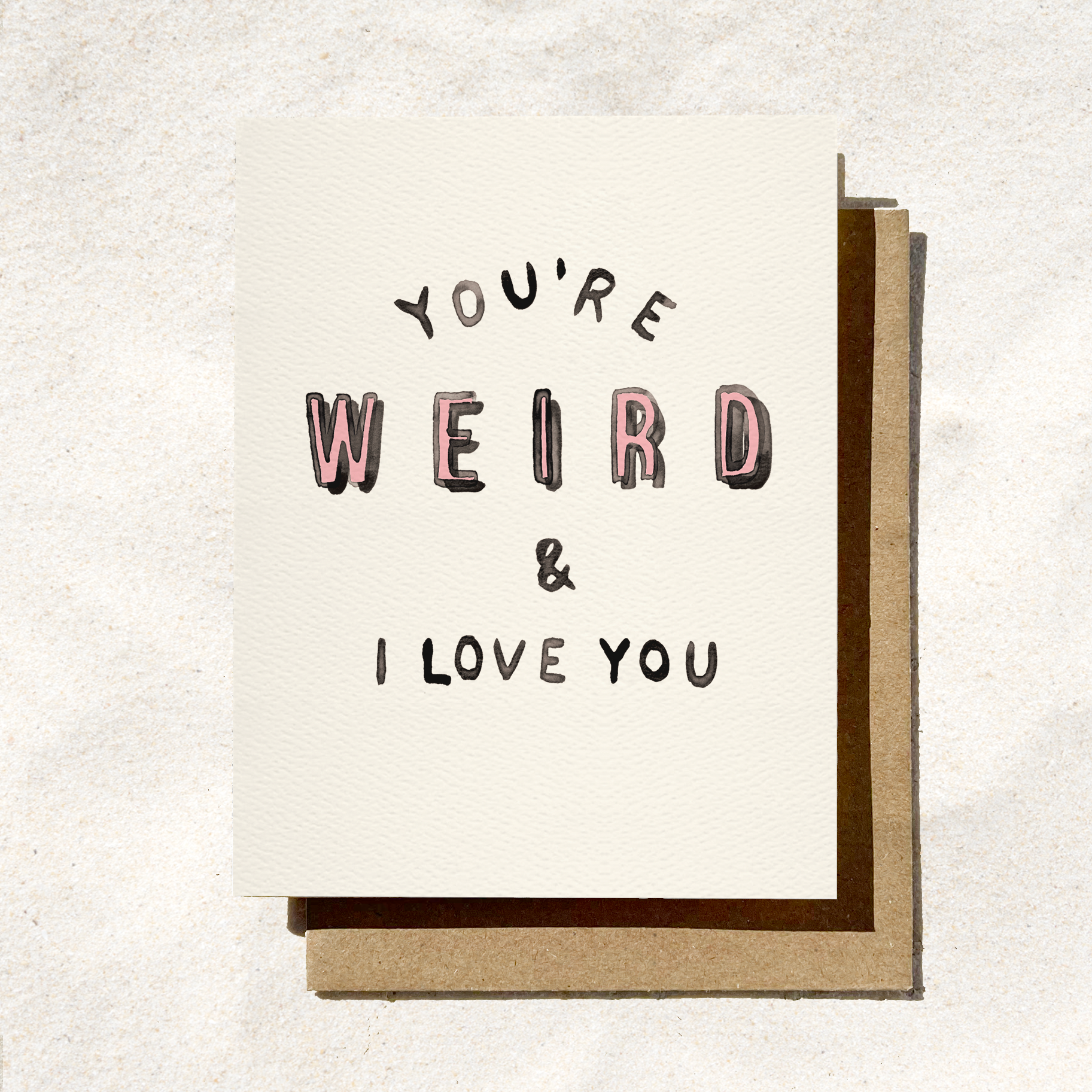 Card with text 'You're Weird & I Love You' on a textured white background