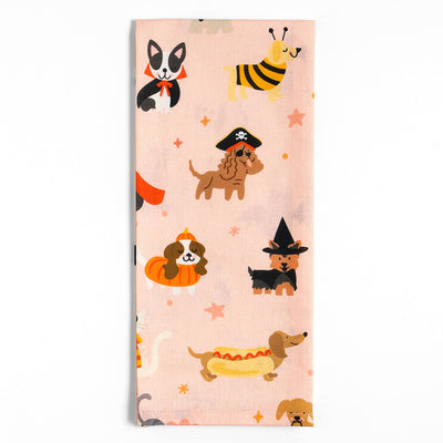 Fabric with Halloween-themed dog illustrations on a pink background